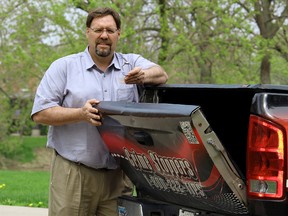 Chatham-Kent Crime Stoppers co-ordinator Const. David Bakker holds a hose clamp to promote one simple solution for pickup truck owners to protect their property from thieves targeting tailgates from vehicles parked across the municipality. PHOTO TAKEN Wednesday, May 6, 2015.  (VICKI GOUGH/ CHATHAM DAILY NEWS/ POSTMEDIA NETWORK)