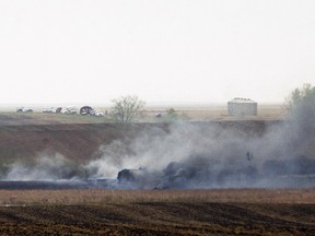 Smoke from the wreckage of several oil tanker cars that derailed in a field near the town of Heimdal, N.D., May 6, 2015. (ANDREW CULLEN/Reuters)