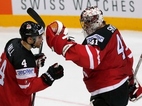 Taylor Hall and Mike Smith celebrate after Canada beat Sweden 6-4 Wednesday during the World Hockey Championship in Prague, Czech Republic. (David W. Cerny, Reuters)
