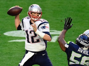 Patriots quarterback Tom Brady (left) throws the ball as he is pressured by Seahawks defensive end Cliff Avril (right) during Super Bowl XLIX in Glendale, Ariz., on Feb. 1, 2015. (Kirby Lee/USA TODAY Sports)