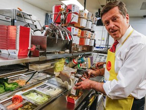 Mayor John Tory at McDonald's on Yonge St. making BigMacs on Wednesday, May 6, 2015. (Dave Thomas/Toronto Sun)