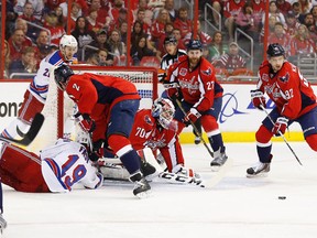 Washington Capitals goalie Braden Holtby (70) makes a save on New York Rangers right wing Jesper Fast (19) in the first period of Game 4 of their playoff series on May 6. (Geoff Burke-USA TODAY Sports)