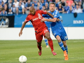 Montreal Impact midfielder Eric Alexander (right) tries to slow down Toronto FC midfielder Collen Warner last night. (USA Today Sports)