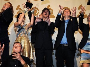 Arcade Fire pose with their awards during the 53nd annual Grammy Awards in 2011. (AFP PHOTO / GABRIEL BOUYS)