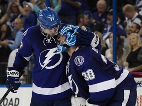 Tampa Bay Lightning goalie Ben Bishop and defenceman Victor Hedman celebrate the 2-1 victory following the third period of Game 3 of the second round of the 2015 Stanley Cup Playoffs at Amalie Arena on May 6, 2015. (Kim Klement/USA TODAY Sports)