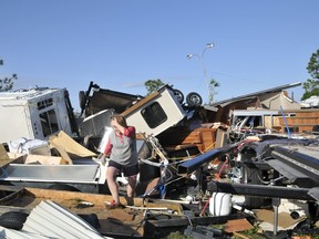 Sharon Odom looks over what is left of her RV at the Roadrunner RV Park in Oklahoma City, Oklahoma May 7, 2015. About a dozen people were injured by a series of tornadoes that touched down southwest of Oklahoma City. (REUTERS/Nick Oxford)