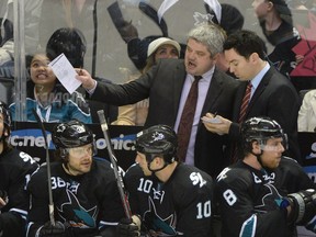 San Jose Sharks head coach Todd McLellan (left) talks to assistant coach Jay Woodcroft (right) during the third period against the Edmonton Oilers at SAP Center at San Jose. The Sharks defeated the Oilers 5-1. (Kyle Terada-USA TODAY Sports)