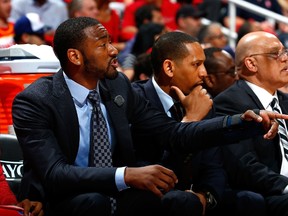 Washington Wizards point guard John Wall, left, helps coach his teammates from the bench against the Atlanta Hawks during Game Two of the Eastern Conference Semifinals of the 2015 NBA Playoffs at Philips Arena on May 5, 2015 in Atlanta, Georgia. (Kevin C. Cox/Getty Images/AFP)