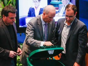 Councillors discussing the new replacement green bins after Giorgio Mammoliti, left, was able to open the locked bin in minutes on Thursday May 7, 2015. (Dave Thomas/Toronto Sun)