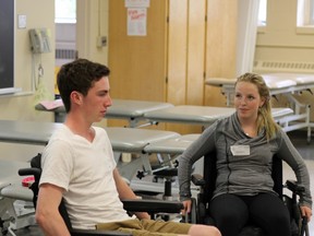 Smiths Falls District Collegiate Institute students Greg Tedford and Hillary Fleming said the workshop on rehabilitation at the TD Discovery Days in Health Sciences program Tuesday at Queen’s University has given them more of an appreciation for the day-to-day struggles Smiths Falls hockey player Neil Doef faces since his spinal cord injury. (Jacob Rosen/For The Whig-Standard)