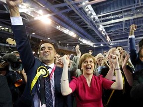 Nicola Sturgeon (C), leader of the Scottish National Party, reacts surrounded by candidates and supporters at a counting centre in Glasgow, Scotland, May 8, 2015. REUTERS/Russell Cheyne
