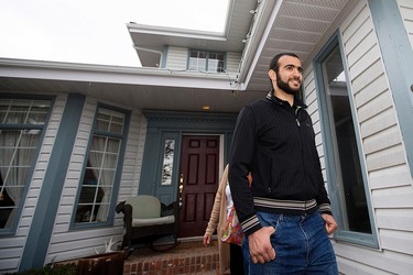 Omar Khadr walks out of his lawyer's west Edmonton home, where he will be staying after being granted parol, in Edmonton, Alta. on Thursday May 7, 2015. David Bloom/Edmonton Sun/Postmedia Network