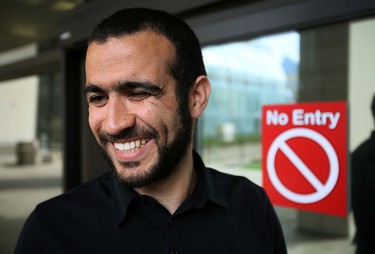 Omar Khadr smilies outside the  Edmonton Law Courts Buildings on Thursday afternoon on May 7, 2015 after Alberta's highest court released the former Guantanamo Bay detainee on bail Thursday pending the appeal of his convictions in the United States.  Tom Braid/Edmonton Sun/QMI Agency