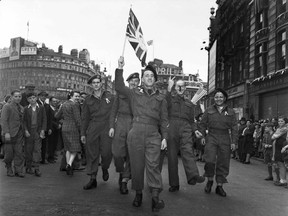Canadian soldiers celebrate VE-Day at Piccadilly Circus, London, May 8,1945, in this handout photo provided by Library and Archives Canada. Seventy years ago, following the suicide of Nazi leader Adolf Hitler, Germany's head of state Karl Donitz signed his country's surrender to Allied forces in Reims, France on May 7, 1945 and in Berlin on May 8, 1945.  REUTERS/Lieut. Arthur L. Cole/Canada Department of National Defence/Library and Archives Canada/PA-176695/