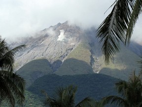 Bulusan volcano as seen from a highway in Irosin town, Sorsogon province, south of Manila on May 8, 2015, two days after it spewed ash. Hundreds fled from the slopes of a restive Philippine volcano on May 8, after authorities warned that rains from an approaching typhoon could trigger mudflows. AFP PHOTO / Charism Sayat