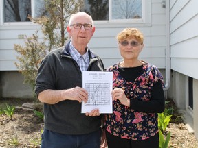 Dean Hodgson and Glenda Young hold up a copy of Sombra Farms, Volume 2, a compliation of 14 stories from small family farms located in the former Sombra Township. The book will be on sale at the Sombra Museum starting May 16. Carl Hnatyshyn/ Postmedia Network