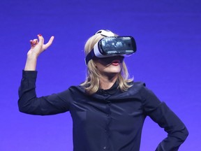 Television presenter Rachel Riley tries the new Samsung Gear VR device at the Unpacked 2014 Episode 2 event ahead of the IFA Electronics show in Berlin, Sept. 3, 2014.    REUTERS/Hannibal Hanschke