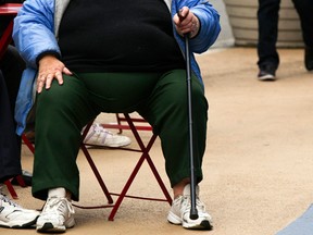 An overweight woman sits on a chair in Times Square in New York, in this May 8, 2012 file photo. REUTERS/Lucas Jackson/Files
