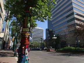 Trees can be seen draped in yarn along Jasper Avenue in downtown Edmonton on July 13, 2014. The art installations are part of an awareness campaign to bring attention to the 2014 'Prairies' Focus on Fibre Art Association Show happening at Enterprise Galleries, 10230 Jasper Avenue, until Aug. 31, 2014. Trevor Robb/Edmonton Sun