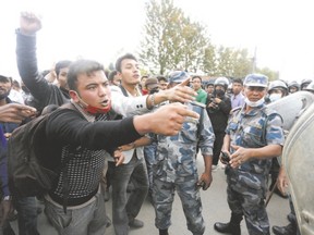 Earthquake victims argue with police officers during a protest against the government?s lack of aid provided to the victims in Kathmandu, Nepal. Canadian UN intern Nicholas DiClemente, based in Nepal, sees these kinds of protests as part of a pattern of anti-government sentiment that preceded the quake. (Adnan Abidi, Reuters)