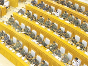Military members of parliament attend the union parliament session in Naypyidaw, Burma. With a quarter of parliamentary seats and an effective veto on opposition leader Aung San Suu Kyi?s presidential hopes, unelected military men have a major role in the country?s delicate political transition, regardless of the result of landmark elections later this year. (Soe Than Win, AFP photo)