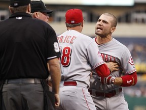 Joey Votto of the Cincinnati Reds is restrained by manager Bryan Price in front of home plate umpire Chris Conroy after being kicked out of the game against the Pittsburgh Pirates at PNC Park on May 6, 2015 in Pittsburgh. (Justin K. Aller/Getty Images/AFP)