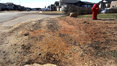 Sidewalks and streets are still battered along the south edge of Slave Lake on Tuesday April 21, 2015 in Slave Lake, AB. The sidewalks and streets are the last projects to be completed in the town's four-year reconstruction plan following the 2011 Slave Lake fires. Trevor Robb/Edmonton Sun/Postmedia Network