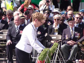 Premier Kathleen Wynne lays a wreath at the foot of the Tomb of the Unknown Soldier as veterans marked the 70th anniversary of VE Day Friday. AEDAN HELMER/ OTTAWA SUN