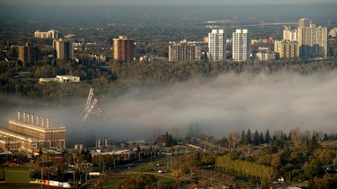 An impressive fog bank covers the new Walterdale Bridge project is seen sticking up behind the downtown core as it rolled through Edmonton's river valley as the sun rose on Friday on May 8, 2015. Lincoln Ho/Edmonton Sun Reader Photo