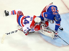 New York Rangers left winger Chris Kreider (20) and Washington Capitals defenceman Brooks Orpik (44) collide with Capitals goalie Braden Holtby during the second period of Game 5 Friday at Madison Square Garden. (Brad Penner/USA TODAY Sports)