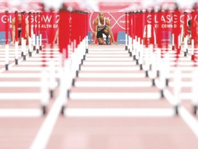 Canada's Damian Warner settles into the blocks before the start of his heat in the men's decathlon 110m hurdles athletics event at Hampden Park during the 2014 Commonwealth Games in Glasgow, Scotland on July 29, 2014.  (AFP file photo)