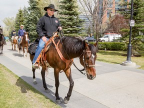 Master Cpl. Paul Nichols, a former Calgary Highlander, rides his horse Zoe along the Bow River Pathway in Calgary, Alta., on May 8, 2015. Nichols is riding across Canada to raise money and awareness of the issues facing Canada's war vets. (Lyle Aspinall/Postmedia Network)