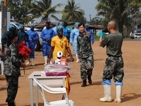 Liberia's last known Ebola patient Beatrice Yardolo (in yellow) arrives for a ceremony at the Chinese Ebola treatment unit, where she was treated, in Monrovia, Liberia, March 5, 2015. (REUTERS/James Giahyue)