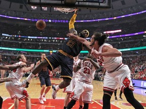 LeBron James of the Cleveland Cavaliers dunks over Joakim Noah of the Chicago Bulls in Game 3 of the Eastern Conference semifinals of the 2015 NBA playoffs at the United Center on May 8, 2015. (Jonathan Daniel/Getty Images/AFP)