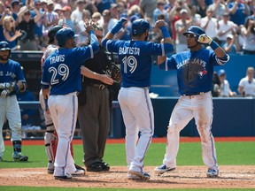 Toronto Blue Jays first baseman Edwin Encarnacion celebrates a home run with teammates Jose Bautista and  Devon Travis during the fourth inning in a game against the Boston Red Sox at Rogers Centre on May 9, 2015. (Nick Turchiaro/USA TODAY Sports)