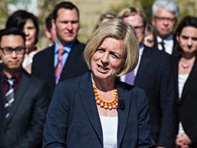 Premier-designate Rachel Notley addresses the media with her caucus behind her during the new NDP government's first caucus meeting at Government House in Edmonton, Alta. on Saturday, May 9, 2015. Codie McLachlan/Edmonton Sun/Postmedia Network