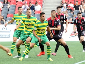 Ottawa Fury FC defenders Rafael Alves and Drew Beckie try to get into position inside the Tampa Bay box during Saturday's match against the Rowdies at TD Place. (Chris Hofley/Ottawa Sun)
