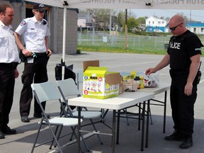 Kingston Police collected an entire garbage bag of prescription medication during the drop off in Kingston, Ont. on Saturday May 9, 2015. Steph Crosier/Kingston Whig-Standard/Postmedia Network