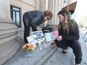 Ginny Kirk (left) and Crystal Clarke, who worked with Tim McLean, set up a tribute to McLean, who was killed by Vince Li aboard a Greyhound bus seven years ago. A small group of people rallied at the Legislative Building in Winnipeg to protest Vince Li's successful application to be moved to a Winnipeg group home. Saturday, May 09, 2015. (Chris Procaylo/Winnipeg Sun/Postmedia Network)