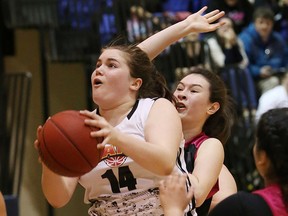 Samantha Martin, left of the Sudbury Jam, goes to the hoop as Kelly McIlroy, of Whitby Gladiators, attempts to block the shot during action at the U17 juvenile girls 2015 Ontario Cup Provincial Championships at Laurentian University in Sudbury on Saturday.