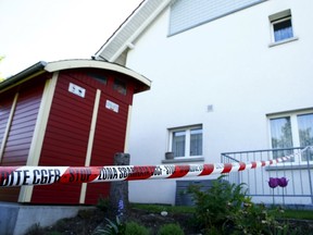 A police ribbon is seen in front of a house in Wuerenlingen, Switzerland on May 10, 2015. Several people were killed in a shooting late on Saturday in a town in the Swiss canton of Aargau, local police said on Sunday. (REUTERS/Ruben Sprich)