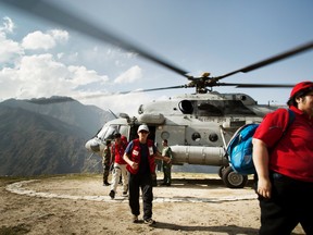 Sarnia Red Cross volunteer Bonnie Kearns is pictured here stepping out of a helicopter in Dhunche, a rural community two hours outside of Nepal's capital city. Red Cross volunteers had to be flown in to the earthquake-stricken countryside because the roads were impassable due to the level of destructions. Kearns, who is a retired Sarnia nurse, arrived to the country two days after its devastating earthquake late last month to help restore medical services.  PHOTO COURTESY OF AAPO HUHTA/FINNISH RED CROSS