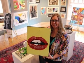 SCITS art teacher Susan VanVeldhuisen shows off an acrylic painting made by her student Kennedy Osborne at the Lawrence House Centre for the Arts on Saturday May 9, 2015 in Sarnia, Ont. More than 125 pieces of Sarnia-Lambton high school art -- from paper-crafted bowls and felted landscapes through to more traditional pencil portraits and oil paintings -- are on display for the month of May. (Barbara Simpson/Sarnia Observer/Postmedia Network)