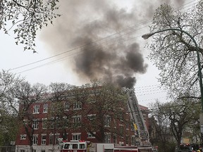 Winnipeg firefighters battle a blaze in an apartment building at Bannatyne Avenue and Kate Street in Winnipeg, Man. Sunday May 10, 2015. (Brian Donogh/Winnipeg Sun)