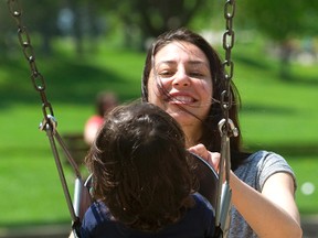 Mary Elejel plays with daughter Ameena, 2, in London?s Springbank Par Sunday. Ottawa is concerned some parents are missing out on the new child-care benefit. (MIKE HENSEN, The London Free Press)