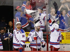New York Rangers players celebrate on the bench in the third period in Game 6 of the second round of the 2015 NHL playoffs against the Washington Capitals at Verizon Center on May 10, 2015. (Geoff Burke/USA TODAY Sports)