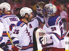 Rangers forward Martin St. Louis celebrates with goalie Henrik Lundqvist after beating the Capitals last night to force a Game 7. (AFP)