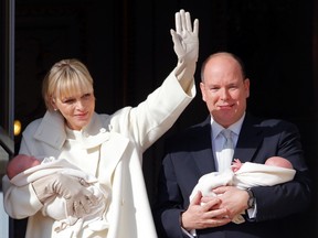 Prince Albert II of Monaco and his wife Princess Charlene hold their twins Prince Jacques and Princess Gabriella as they stand at the Palace Balcony during the official presentation of the Monaco's newborn royals in Monaco January 7, 2015. Monaco has declared a public holiday on January 7th to celebrate the birth of twin heirs, Crown Prince Jacques Honore Rainier and Princess Gabriella Therese Marie who were born on December 10, 2014. (REUTERS/Eric Gaillard)