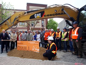LUKE HENDRY/ THE INTELLIGENCER
Mayor Taso Christopher, far left, swings the shovel during the groundbreaking for the first phase of Build Belleville's downtown renewal project in Belleville, Monday. This phase will see the installation of a new water main and sewer pipes, plus improved sidewalks, lighting and more.
