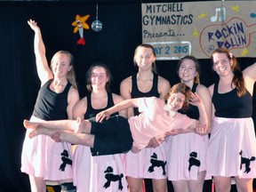 The Senior Gym Team of Lydia Power (left), Stacey Louwagie, Janis Louwagie, Laura Fischer and Char Louwagie hold on to Gage Rohfritsch in the finale of their Rock & Roll Mash Up routine. ANDY BADER/MITCHELL ADVOCATE